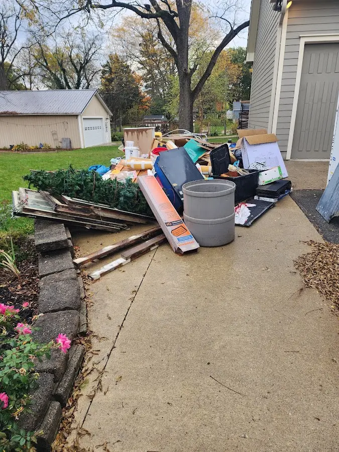 Dumpster being loaded with debris for 12 Yard Dumpster Rental in Greenburgh